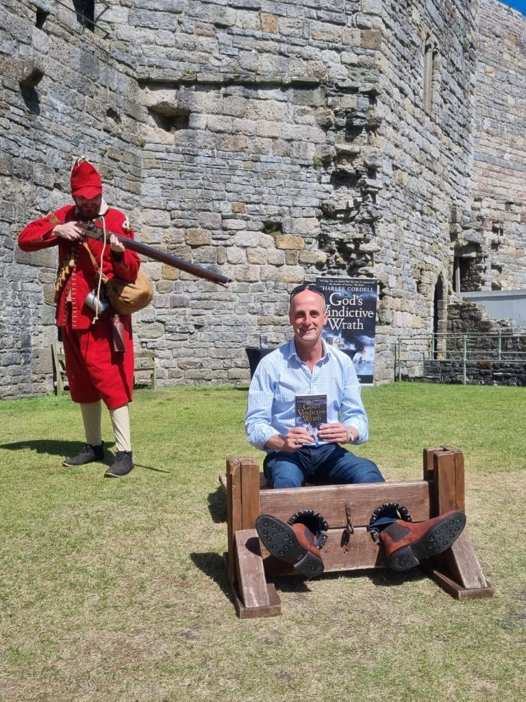 CHARLES CORDELL in the stocks at Caernarfon Castle