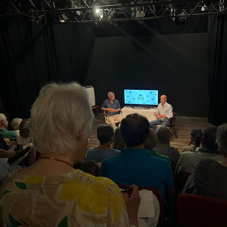 Charles Cordell on stage at the Tabard Theatre during the Chiswick Book Festival, in discussion with historian Julian Humphrys.