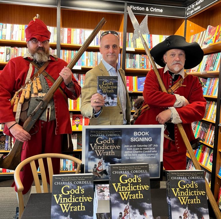 Historical fiction author Charles Cordell with English Civil War re-enactors and his debut novel God's Vindictive Wrath.